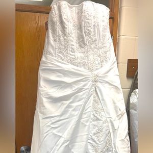 This is a new wedding dress, with a cathedral veil, train and a bridesmaid dress